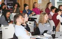 Photo of young people sitting in workshop