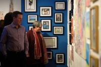 People viewing work at the Museum of Carefree exhibition at Penlee House Museum & Gallery