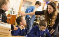 Photo of Cap-a-Pie cast member working with a group of young school children