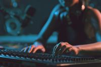 The hands of a woman using a mixing desk