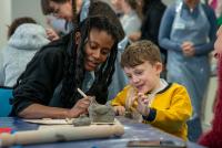 Woman and child working together modelling some clay