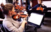 a group of woodwind musicians perofrming in a room