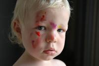 Photo of a child with paint on his face