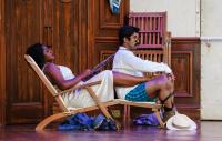 Photo of opera singers sitting in deck chairs on a ship