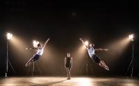 three ballet dancers performing on stage