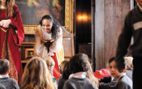 performer speaks to children