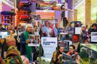 Climate change activists with banners protesting inside the Science Museum