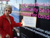 Image of Ann Webb in front of poster