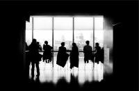 Photo of people sitting in front of a large window