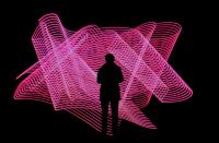 Silhouette of a person in front of a neon pink light display