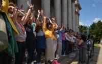 A choir performing out the front of the Fitzwilliam Museum