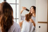 Woman singing into hairbrush