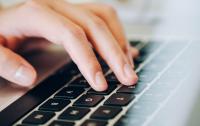 A photo of a hand on a keyboard