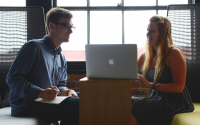 two people discuss a business meeting