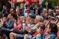 National Festival of Making 2022. People sat on folding wooden chairs smiling, laughing and clapping.