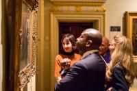 Photo of people looking at a painting in gallery