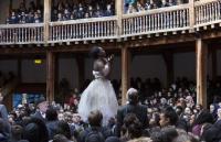 Photo of young people watching woman on stage