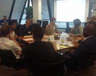 Photo of people sitting round a table at a workshop