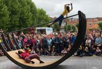 Photo of street art, woman hoisted on seesaw