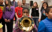 Photo of child playing trumpet