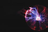 Hand on plasma ball lamp