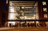 Sadler's Wells building at night with crowd