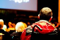 Individual in a wheelchair watches arts event