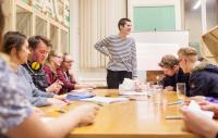 Photo of young people round table