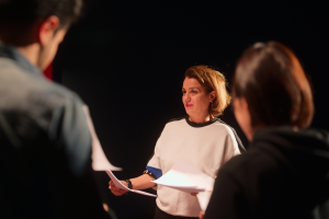 Group of theatre professionals onstage