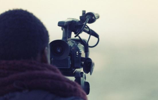 A photo of a man behind a camera