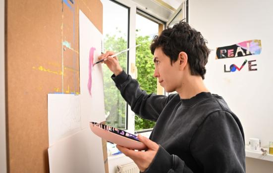 A person painting in a workspace