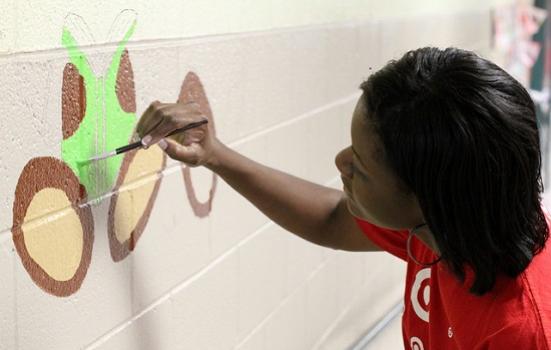 A photo of a woman painting