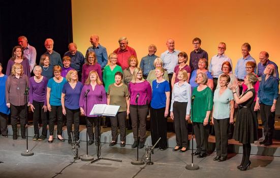 A choir of people wearing colourful clothes