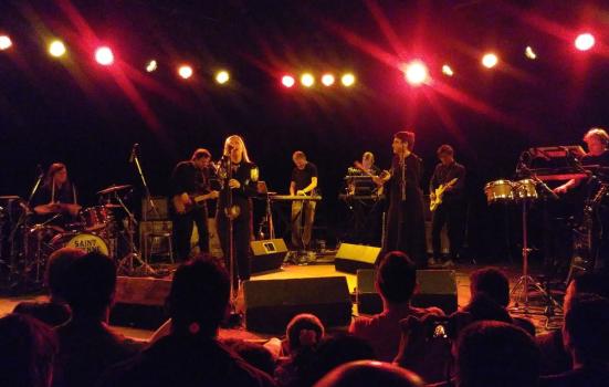 Band playing in front of a crowd at a small venue