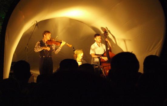 Musicians on stage in front of a crowd