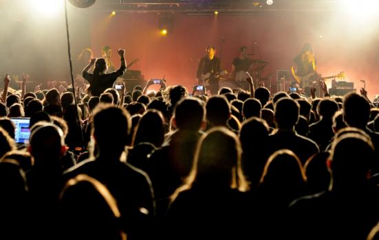 photo of band playing a concert to an audience