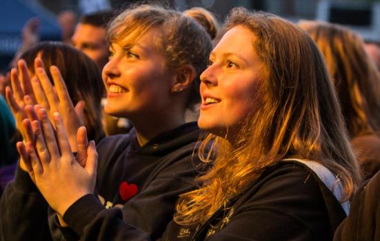 Photo of girls watching show and clapping