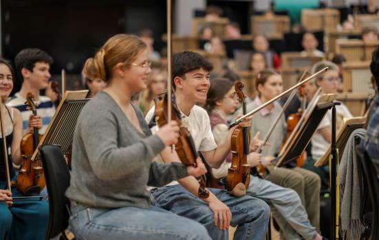 Young people playing classical music instruments