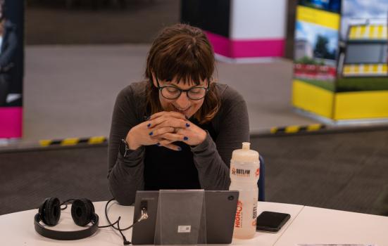 Woman sitting at a desk in front of a laptop