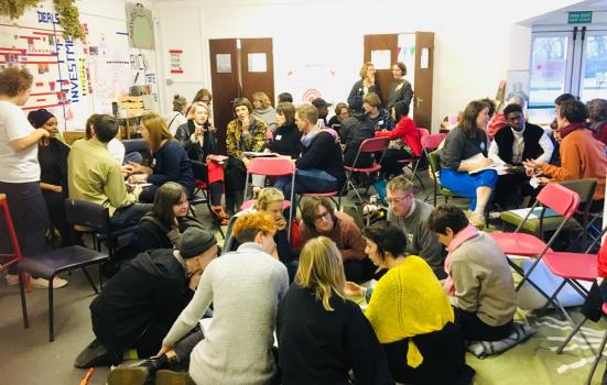 A photo of groups of people sitting in a room