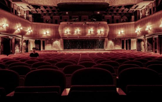 Photo of interior theatre with a single spectator