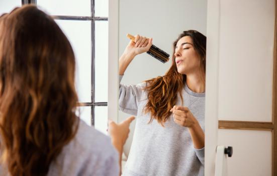 Woman singing into hairbrush