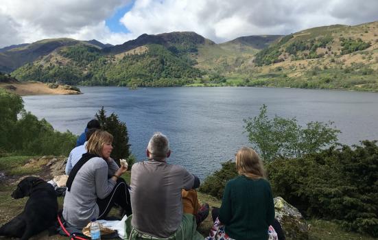 Photo of people sitting by lake