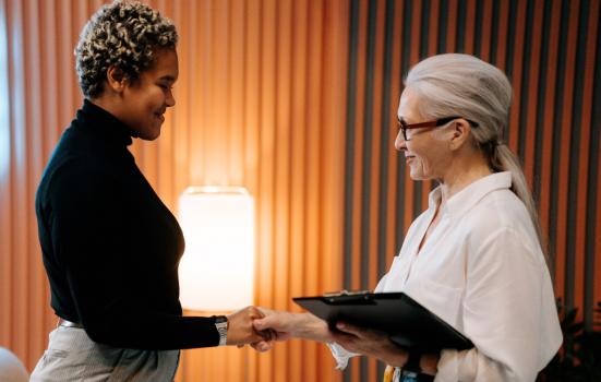 two women shaking hands