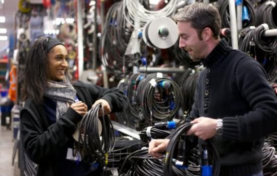 Photo of two young people holding cables