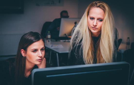 Photo of women looking at computer monitor