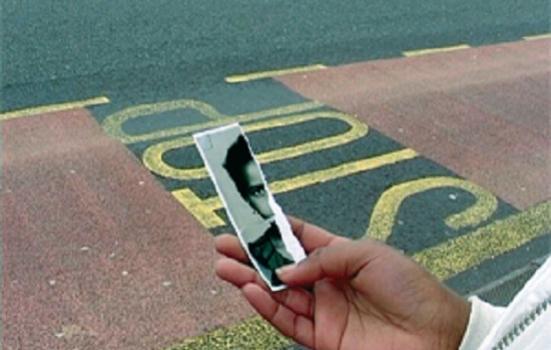 Photo of person holding torn photo