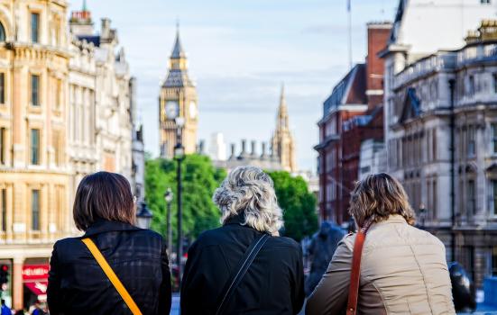 Photo of three women looking at buildings