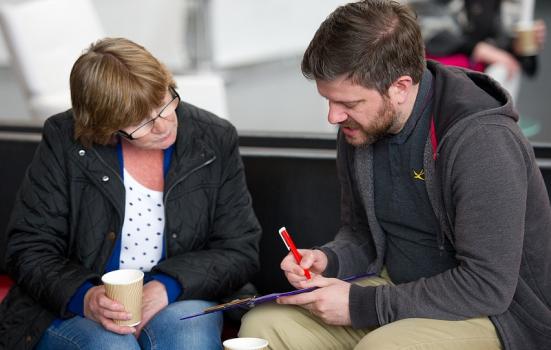 Photo of researcher talking to member of the public