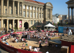 A makeshift beach is assembled outside a building